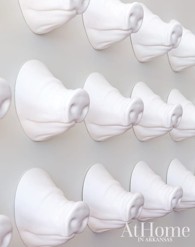 White pig snout wall hooks arranged in a grid pattern.