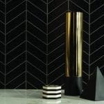 Matte black chevron tile with thin grey grout lines