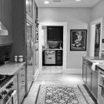 Kitchen with dark grey cabinets, stainless steel appliances, and a Persian rug.