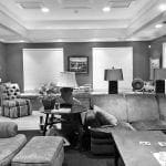 Living room with sectional sofa, armchair, ottoman, and coffee table.