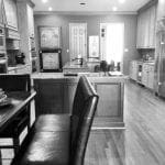 Kitchen with dark leather bench seating, granite island, and wood floors.