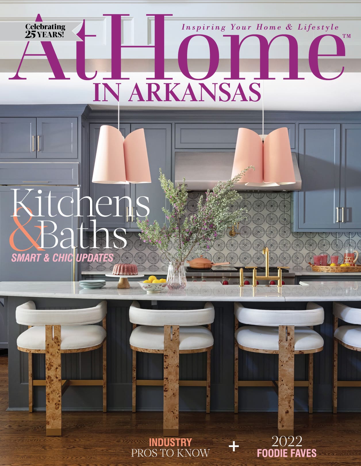 At Home in Arkansas magazine cover featuring a kitchen with gray cabinets, pink pendant lights, and
