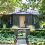 Dark brick house with a metal roof and a front porch.