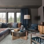 Gray living room with blue curtains, sofa, and coffee table.