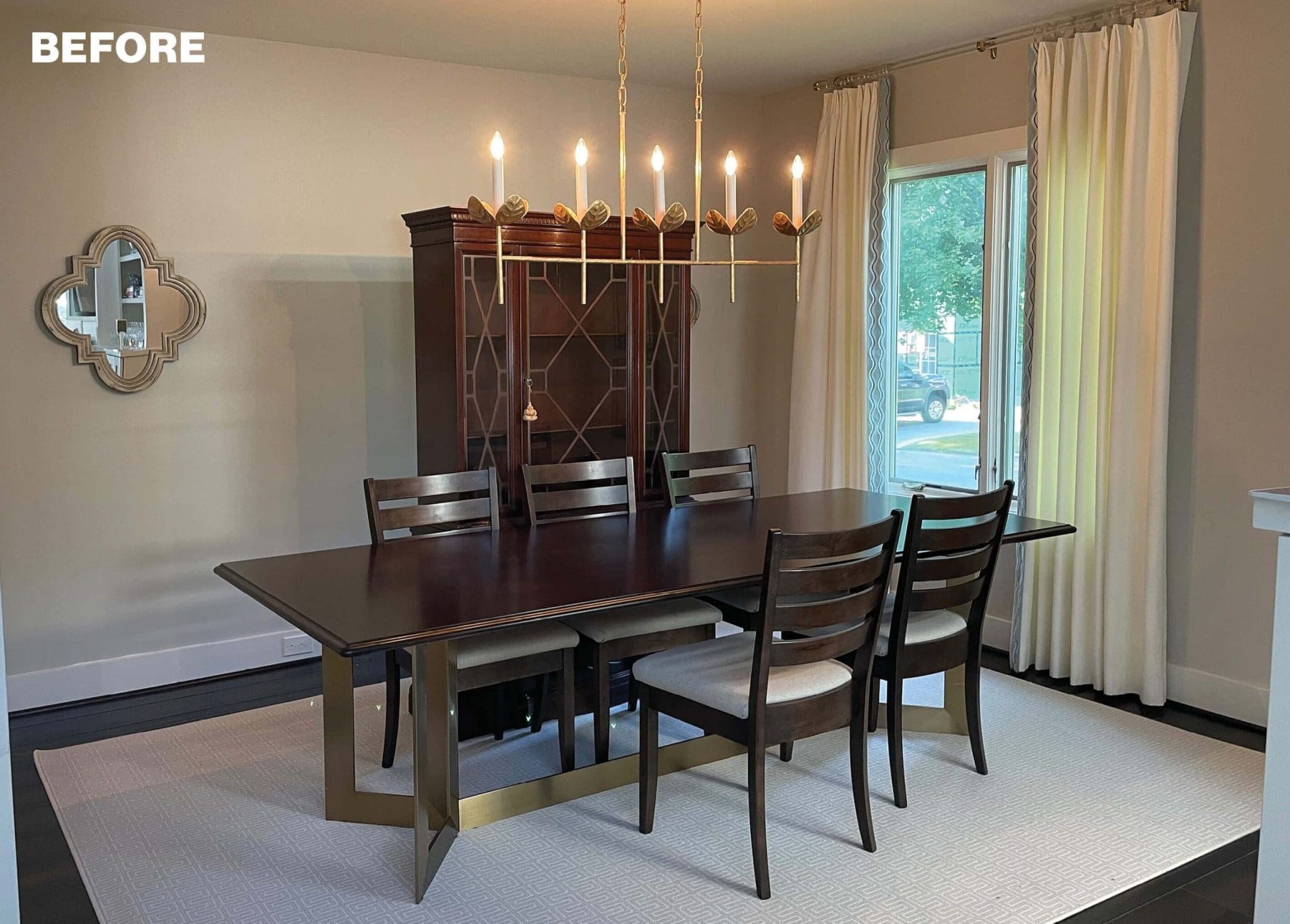 Dining room with dark wood table, chairs, and a large cabinet.