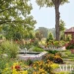 Lush garden with a fountain and red gazebo in Arkansas.
