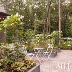 Outdoor patio with string lights, roses, and seating.