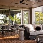 Covered patio with seating, table, and outdoor furniture.