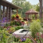 Red gazebo and flower garden with a stone pool in Arkansas.