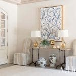 Cream-colored hallway with arched doorway and artwork.