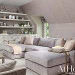 Upholstered gray sectional sofa with pillows in a reading nook.