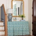 Blue and white ikat fabric console table with mirror and lamp.