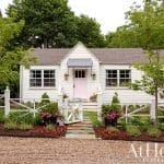 White cottage with pink door and landscaping, Arkansas