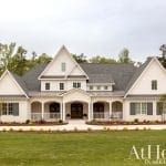White, two-story house with gabled roof and porch in Arkansas.