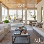Covered porch with sofas, coffee table, and outdoor decor.