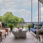 Outdoor seating area with a rope swing and patterned rug.