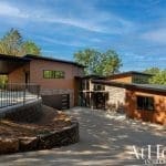 Modern home with brown wood siding and stone accents, Arkansas