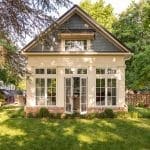 Light yellow cottage with gray shingles and windows, Arkansas