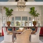 Blue-painted ceiling, lantern, and seating area in a covered porch.