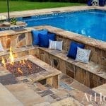 Outdoor seating area with a fire pit and blue cushions.