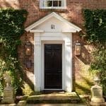 Brick house facade with a black door and number 51