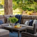 Stone pillar with outdoor seating and a coffee table.