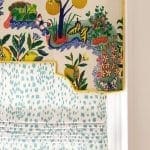 Textile with floral and citrus motif, green patterned blind.