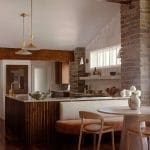 Stone wall kitchen with wooden beams and island.