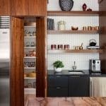 Wooden cabinetry with a built-in pantry and shelving.