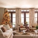 Large living room with a Christmas tree and patterned drapes.