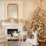 Gold Christmas tree with deer figurines, mirror, and fireplace.