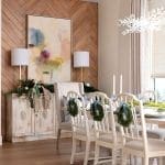 Wood-paneled wall with artwork and table setting.