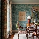 Blue and gold flocked wallpaper with a landscape design.