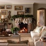 Living room with fireplace, wall of paintings, and garland.