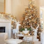 Gold Christmas tree with deer figurines in a living room.