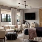Neutral living room with sofa, television, and patterned wallpaper.