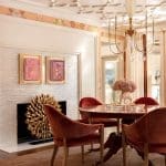 Pink and gold patterned ceiling, fireplace, and dining table.