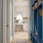 Blue and white paneled entryway with built-in storage.