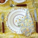 Floral embroidered napkin with monogram 'M' on a table setting