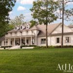 White two-story house with a wide porch in Arkansas.