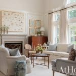 Light-filled living room with a gray sectional sofa and fireplace.