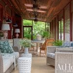Wooden-slatted porch ceiling with lights and seating.