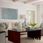 Blue and white patterned artwork, sofa, and coffee table in a living room.
