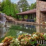 Stone house with waterfall and pond in Arkansas.
