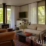 Living room with a fireplace, sofa, and window view.