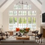 Large windowed living room with white walls and a fireplace.