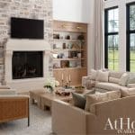 Stone fireplace and built-in shelving in a living room.
