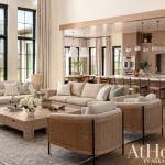 Large living room with sofa, coffee table, and kitchen area.