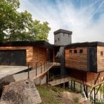 Modern house on a lakefront in Arkansas with wood and metal cladding.