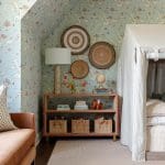 Blue and white wallpapered bedroom with nautical decor.